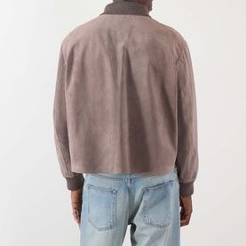 Model wearing JW Anderson Mouse Grey suede casual jacket, rear view, styled with light wash denim jeans