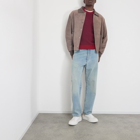 Model wearing JW Anderson Mouse Grey suede casual jacket, styled with red knit, light wash jeans and white trainers
