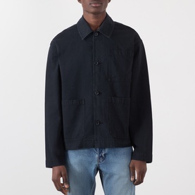 Model wearing JW Anderson black cotton casual jacket with button front, chest pocket, and light blue jeans.