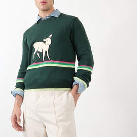 Model wearing JW Anderson Sheep Stripe Sweater in dark fir, featuring front sheep motif and multicolour stripe detail, styled with light blue shirt
