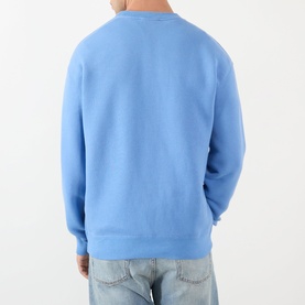 Model wearing JW Anderson Ribbon Anchor Logo Sweatshirt in washed blue. Rear view, crew neck, ribbed trims, styled with light wash jeans.