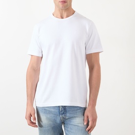 Model wearing JW Anderson Anchor Logo T-Shirt in white, round neck, short sleeves, styled with light blue denim jeans.