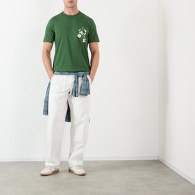 Model wearing JW Anderson Scattered Logo T-Shirt in green with white cargo trousers and blue checked shirt tied at waist.