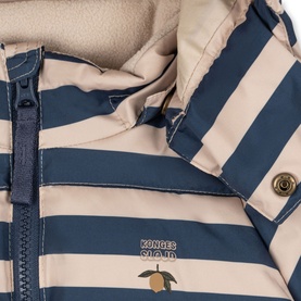 Konges Sl&oslash;jd coat in Bleu Noir stripe, close-up of navy and cream striped exterior with zip fastening and fleece lining.