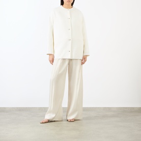 Model wearing Loulou Studio ivory wool-cashmere coat with button front, styled with matching wide-leg trousers and tan flat sandals.