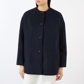 Model wearing Loulou Studio wool cashmere coat in Navy Melange, collarless design with button front and patch pockets.