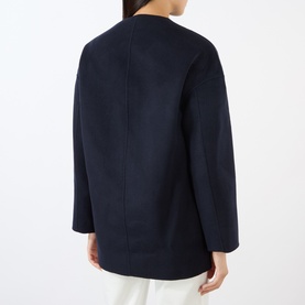 Model wearing Loulou Studio navy melange wool cashmere coat, rear view showing clean seam detail and relaxed boxy silhouette.