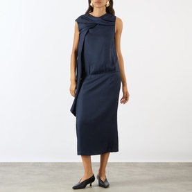 Model wearing Loulou Studio navy silk dress with draped twist neckline detail and sleeveless silhouette, styled with black pointed-toe flats