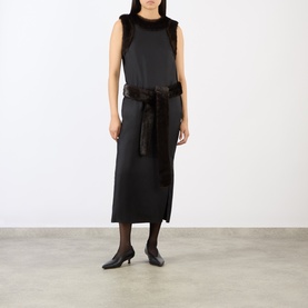 Model wearing Loulou Studio Black/Grizzly silk dress with faux fur trim at shoulders and belt, styled with black tights and kitten heels