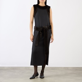Model wearing Loulou Studio Black/Grizzly silk dress with faux fur trim and feather-detailed belt, styled with black heels and tights.