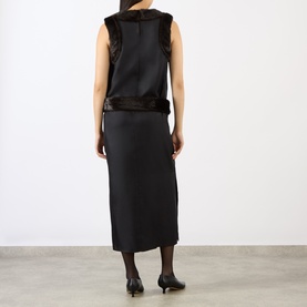 Model wearing Loulou Studio Black/Grizzly silk dress with faux fur trim, sleeveless, midi length, shown from back. Styled with black heels.