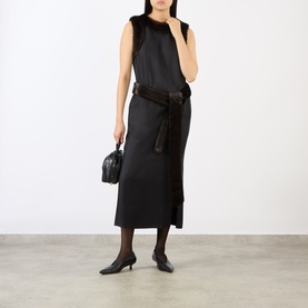 Model wearing Loulou Studio Black/Grizzly silk dress with fur trim neckline and belted waist, styled with black mini bag and heels.