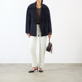 Model wearing Loulou Studio Navy Melange wool-cashmere jacket with white trousers, brown top, and black heels, carrying a small dark bag.