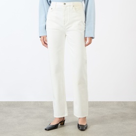 Model wearing Loulou Studio ivory straight-leg jeans with black mule heels and a light blue knit top.