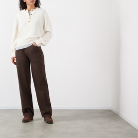 Model wearing Loulou Studio brown wide-leg jeans in 100% cotton, styled with a cream knit polo top and brown loafers.