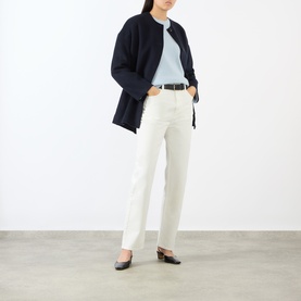 Model wearing Loulou Studio light blue cashmere knit, styled with white straight-leg trousers, black belt and black slingback flats