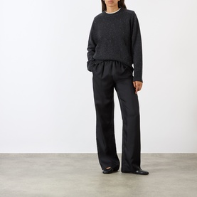 Model wearing Loulou Studio peppered anthracite cashmere knit, styled with matching wide-leg trousers and black flat shoes.