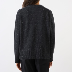 Model wearing Loulou Studio cashmere knit in peppered anthracite, rear view showing relaxed fit, ribbed hem and cuffs.