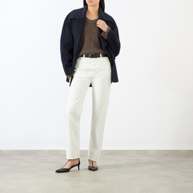 Model wearing Loulou Studio brown cashmere knit top with navy jacket, white straight-leg jeans and black heeled mules.