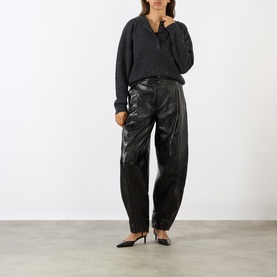 Model wearing Loulou Studio Malo Half-Buttoned Sweater in Peppered Anthracite, styled with wide-leg brown trousers and brown loafers.