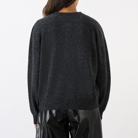 Model wearing Loulou Studio Malo Half-Buttoned Sweater in Peppered Anthracite, rear view, ribbed trims, styled with dark trousers.