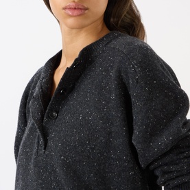 Model wearing Loulou Studio Malo Half-Buttoned Sweater in Peppered Anthracite, crew neck with half-button placket, styled with grey shirt and brown