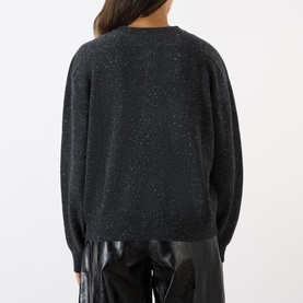 Model wearing Loulou Studio Malo Half-Buttoned Sweater in Ivory cashmere, back view, styled with black patent trousers.