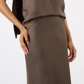 Model wearing Loulou Studio dark brown silk midi skirt with a smooth, sleek finish, styled with a matching dark brown top.