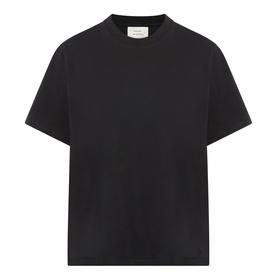 Black crew neck short sleeve T-shirt with relaxed fit and subtle branding at chest, laid flat on white background