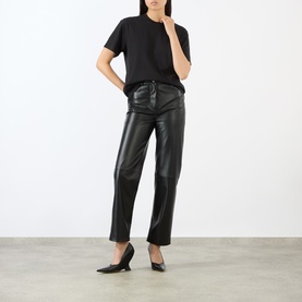 Model wearing black faux leather straight-leg trousers with black T-shirt and black pointed kitten heel mules
