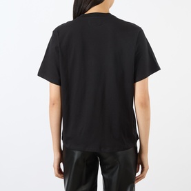 Model wearing black crew neck short sleeve T-shirt, back view, styled with black leather trousers