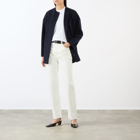 Model wearing Loulou Studio white cotton T-shirt, styled with navy longline jacket, cream straight-leg jeans and black heeled mules.