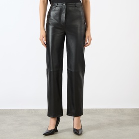 Model wearing Loulou Studio black lambskin leather straight-leg trousers, styled with black pointed-toe heels.