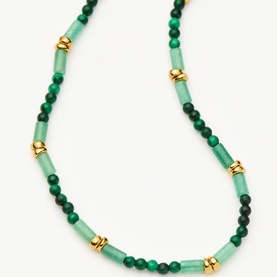 Missoma bracelet in gold and green, featuring alternating jade-tone tube beads, round malachite beads, and gold disc spacers
