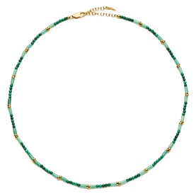 Missoma gold and green beaded necklace with alternating malachite-toned and gold beads, gold lobster clasp fastening