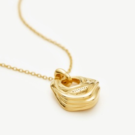Missoma gold necklace with sculptured wave-textured pendant on fine chain
