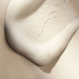 Rituals Gentle Cleansing Foam texture close-up showing creamy white lather with water droplets on skin