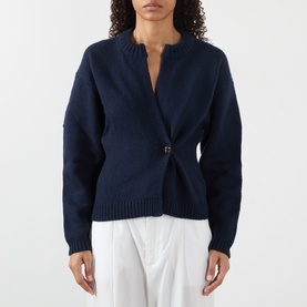 Model wearing Soeur navy merino wool cardigan with wrap front and single buckle detail, styled with white wide-leg trousers