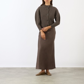Model wearing Soeur brown merino wool cardigan with button front, styled with matching brown maxi skirt and nude flat shoes.