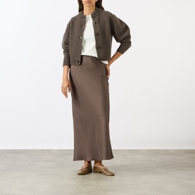 Model wearing Soeur brown merino wool cardigan with white top and brown satin midi skirt, styled with taupe ballet flats.
