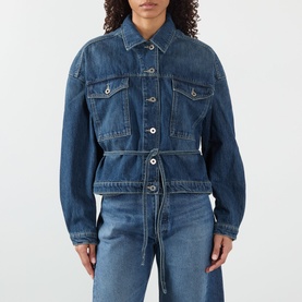 Model wearing Soeur mid blue denim jacket with belted waist, chest pockets and button front, styled with matching wide-leg jeans.