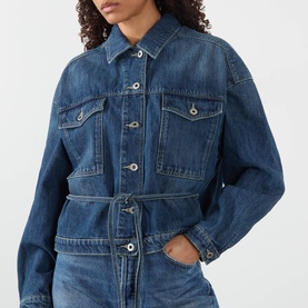 Model wearing Soeur mid blue denim jacket with chest pockets, button front, and belted waist, styled with matching denim