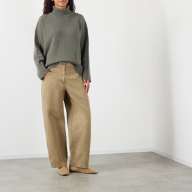 Model wearing Soeur grey merino wool turtleneck knit, styled with wide-leg tan trousers and nude flat shoes
