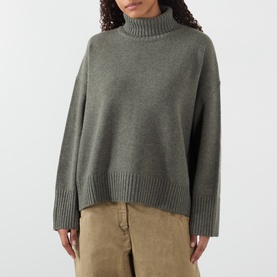 Model wearing Soeur grey merino wool turtleneck jumper with relaxed boxy fit and ribbed hem, styled with tan trousers