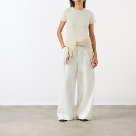 Model wearing Soeur charcoal cotton T-shirt, styled with wide-leg cream trousers and a tied waist wrap