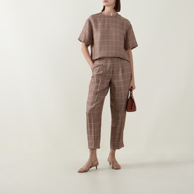 Model wearing Ted Baker beige check trousers with matching top, styled with tan kitten heels and a small brown bag.