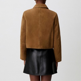 Model wearing Claude Pierlot cropped tan suede jacket, back view, styled with black leather mini skirt
