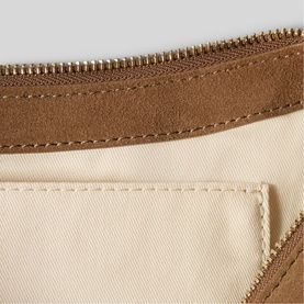Claude Pierlot item in clear, showing cream fabric interior with tan suede trim and gold zip detail close-up.