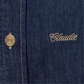 Claude Pierlot Womens French Dress in blue denim, close-up of gold logo embroidery and button detail on denim fabric.