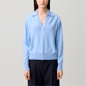 Model wearing Claude Pierlot Logo Polo Sweater in sky blue with shirt collar, gold-tone button placket, paired with navy trousers